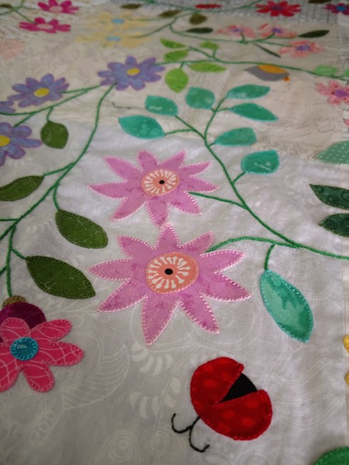 meadow quilt blanket stitch raw edge applique flower leaf vine ladybug
