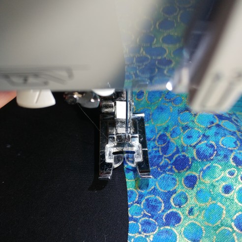 Pulling up bobbin thread to bury on machine applique